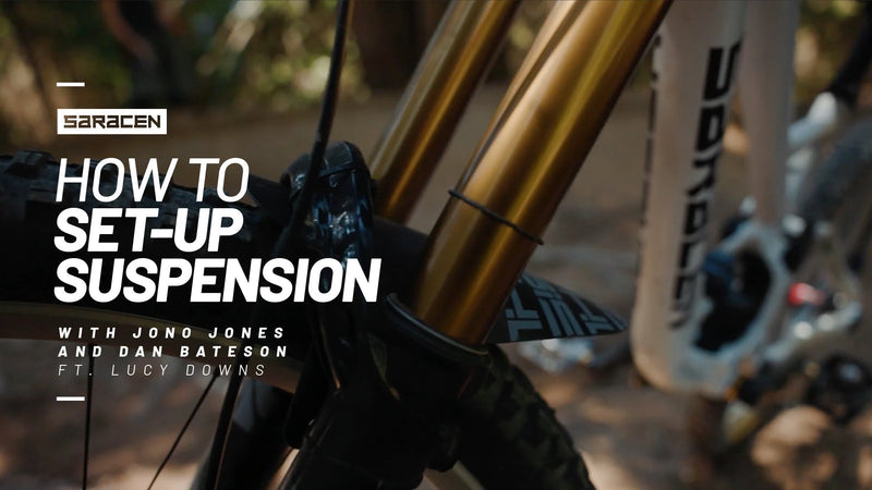 Saracen rider setting up mountain bike suspension before riding