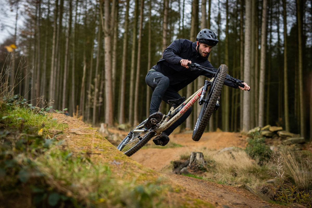 Person riding a mountain bike on a trail in a forest