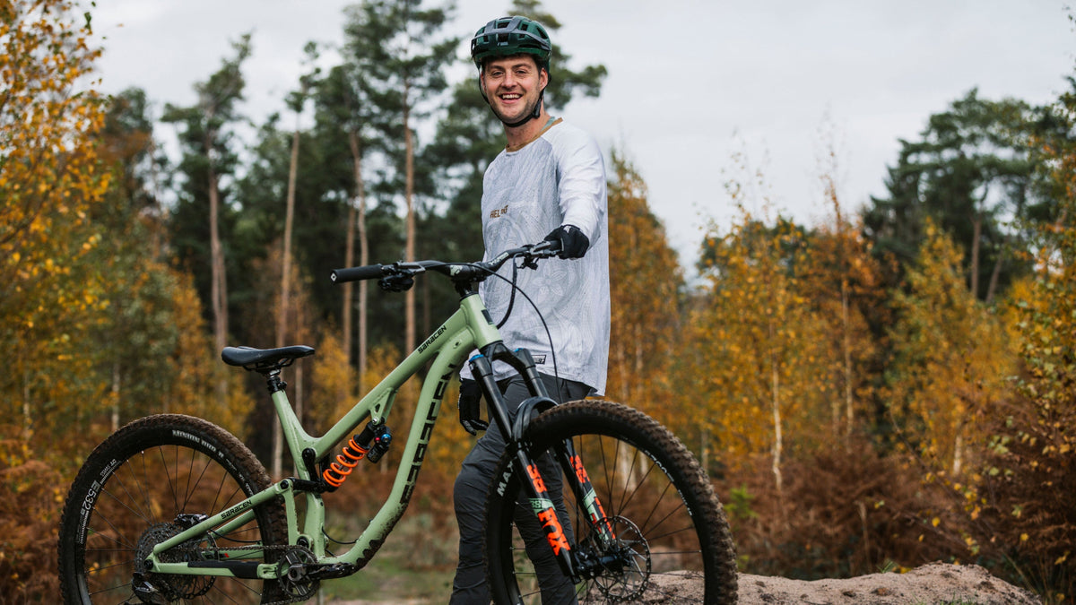 Person with a mountain bike in a forest setting