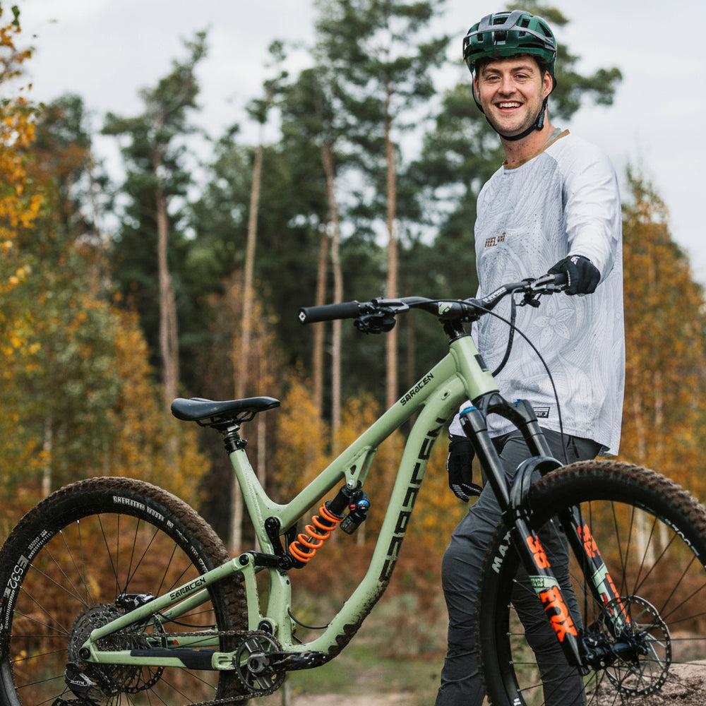 Person with a mountain bike in a forest setting