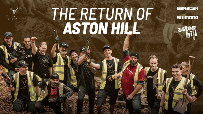 Group of people posing together with text 'The Return of Aston Hill' and brand logos.