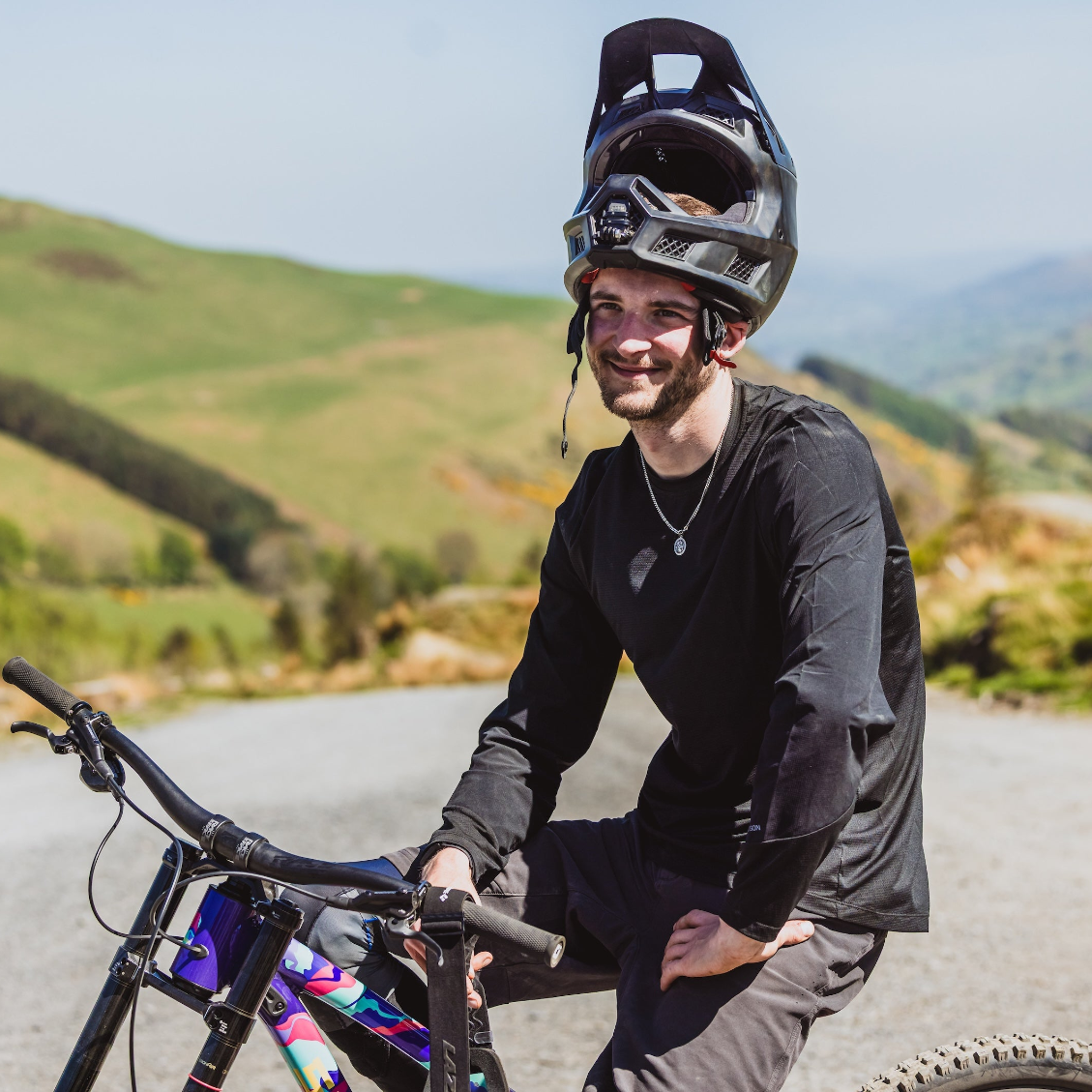 Man with mountain bike helmet on a mountain road