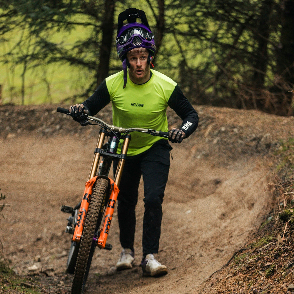 Person riding a mountain bike on a dirt trail in a forest