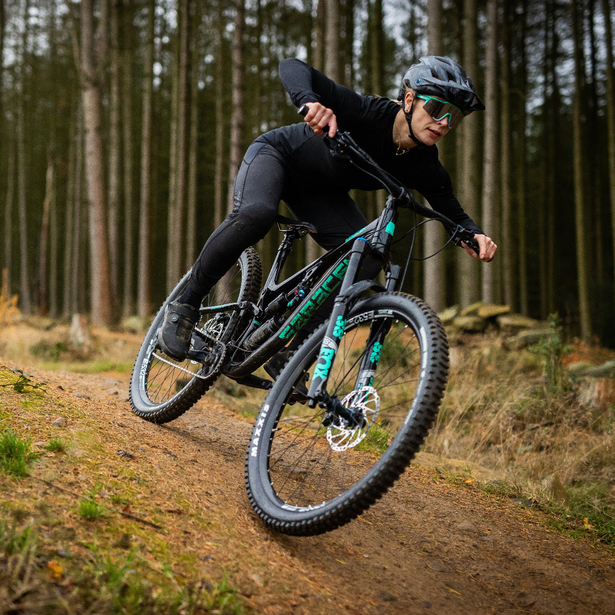 Person riding a mountain bike on a trail in a forest