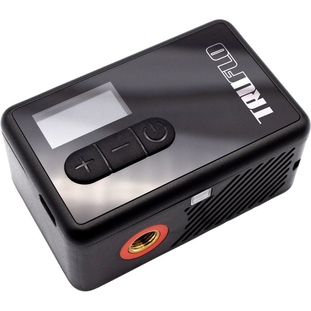 Black electronic device with control buttons and a display on a white background