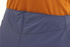 Close-up of blue shorts with an orange shirt underneath