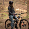 Person with a mountain bike in a forest setting
