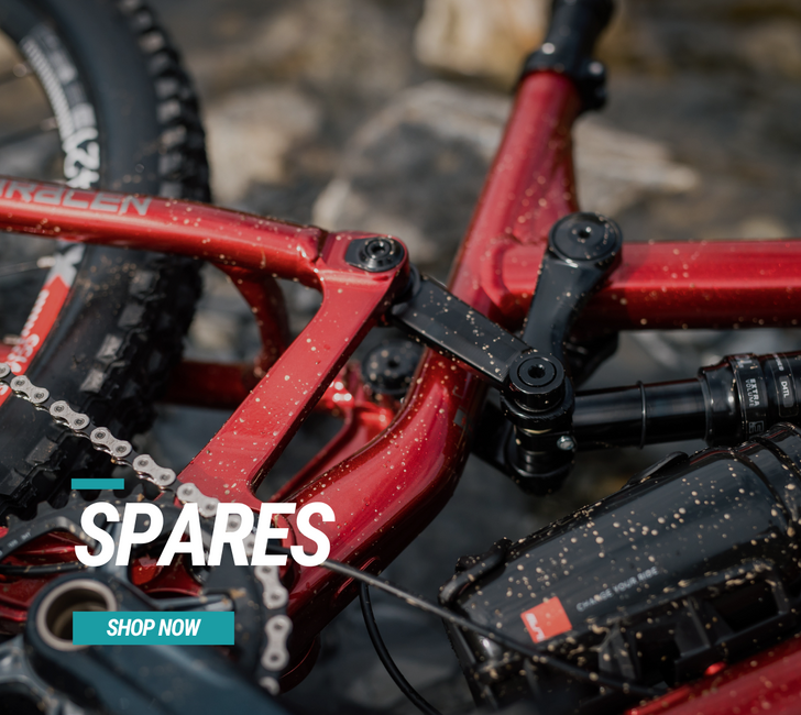 Close-up of a red bicycle frame with 'Spares' and 'Shop Now' text overlay.