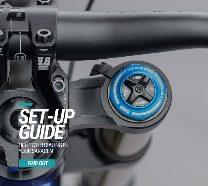 Close-up of a bicycle handlebar with a focus on the Saracen brand, featuring text about a setup guide.